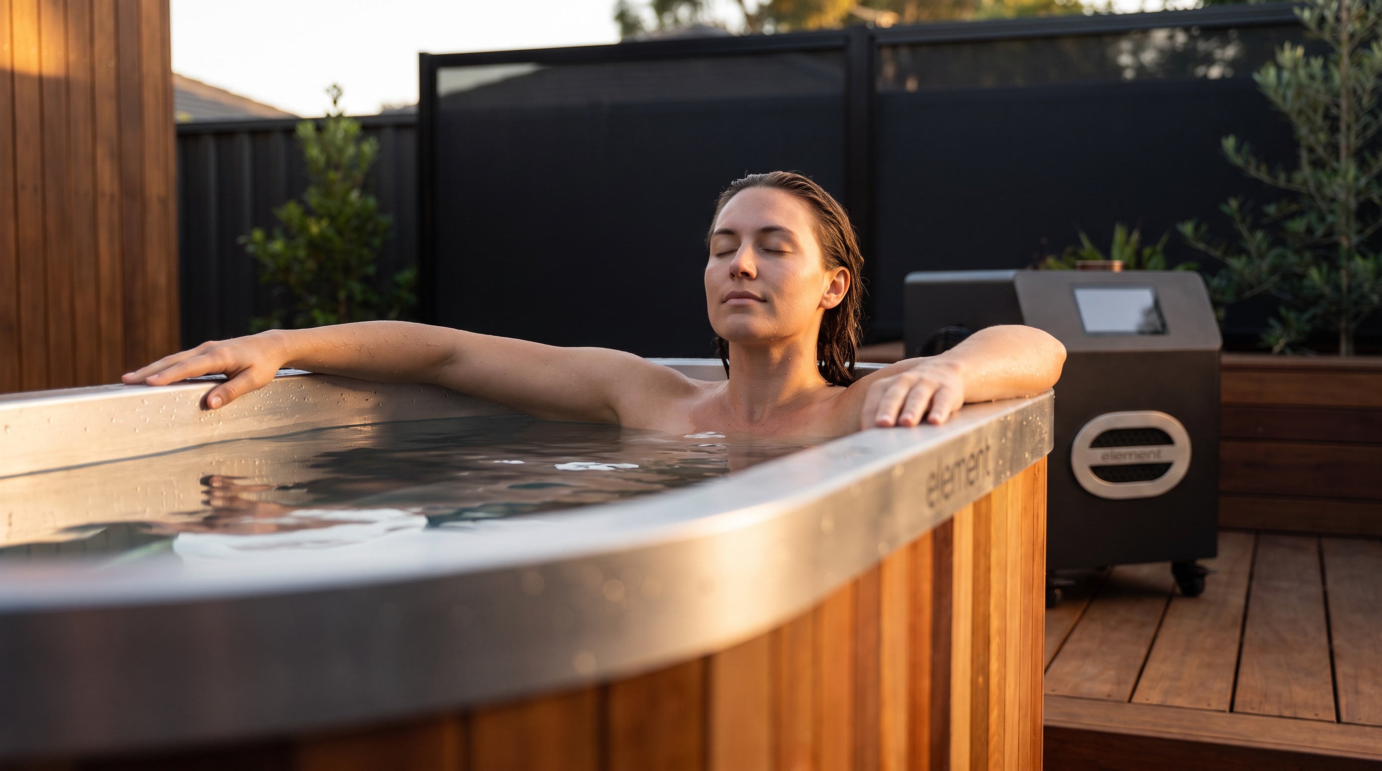 A person enjoying a quiet plunge in Terra with Nova beside the bath